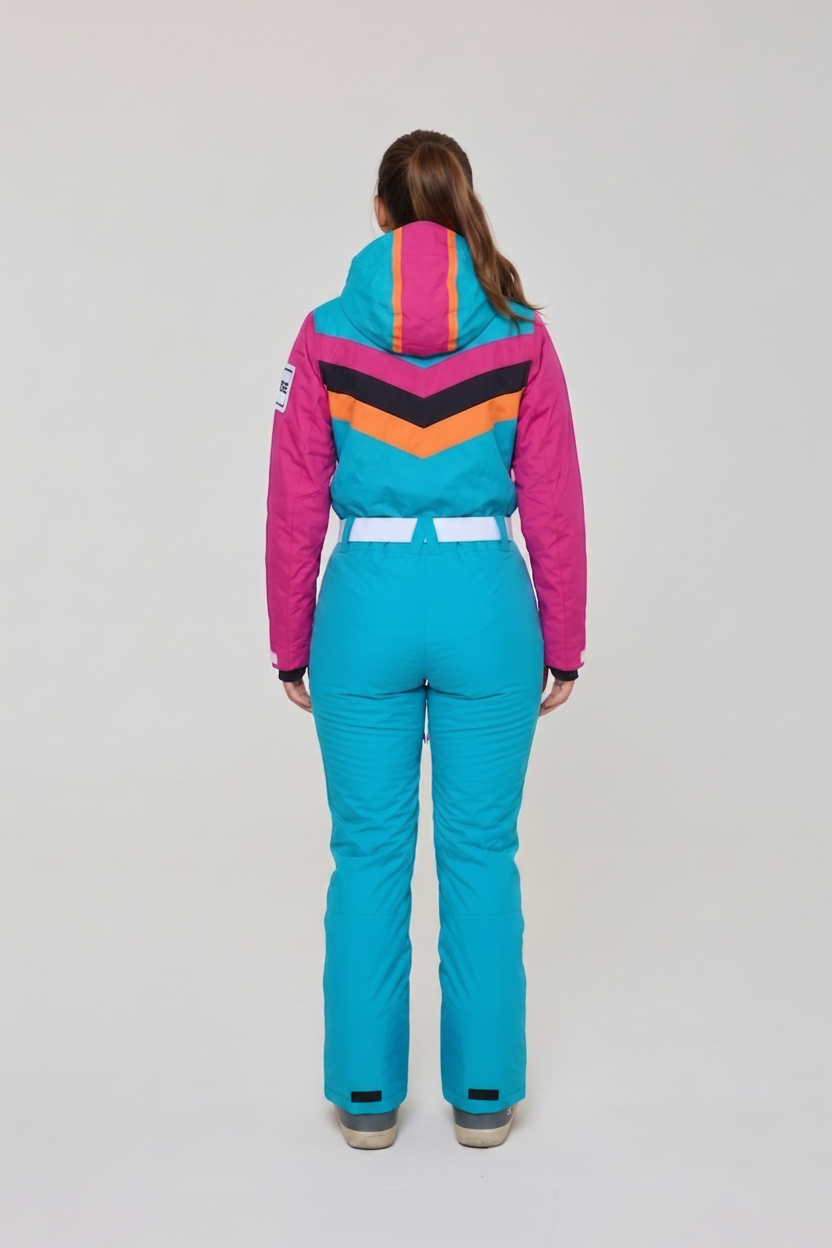 woman wearing a green ski suit with a pink and orange stripes